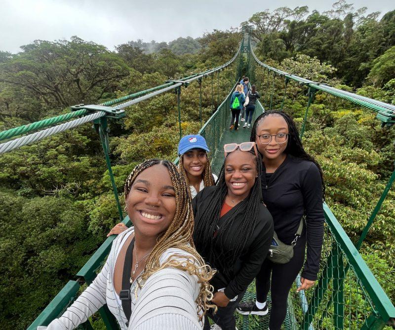 Nakyah Vaughan (at right) on a bridge with friends in Costa Rica.